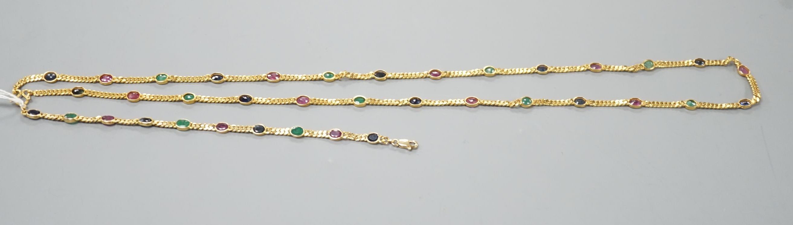A modern Thai yellow metal and oval multi gem set necklace, 68cm and a similar bracelet, stamped 585, 17.5cm, gross weight 35.4 grams.